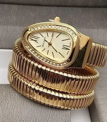 Luxury triple-wrap snake watch in gold and silver with crystal bezel
