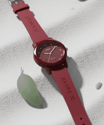 Elegant ladies round dial watch with a deep maroon soft strap.