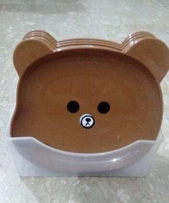 8Pcs Bear Shape Plate Set | Creative Food-Grade Plastic Plates With Stand | Random Colour displayed on a kitchen counter.
