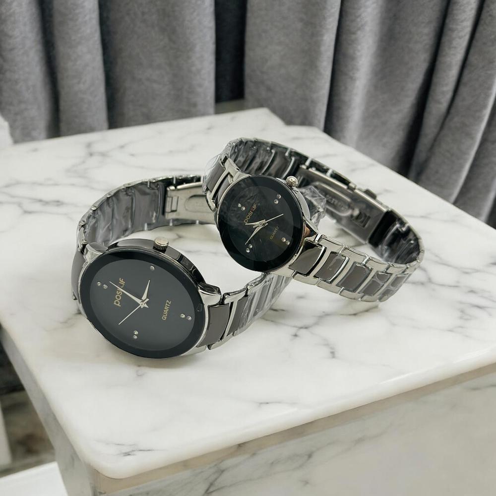 POSITIF Eternal Couple Watch Collection POSITIF matching couple watch set with black dials and silver link bracelets.