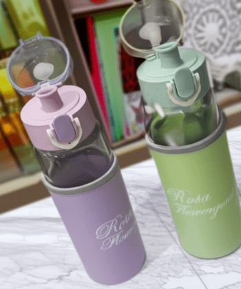 Rosa Flowery Glass Water Bottle with protective sleeve and flip-top cap.