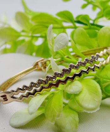 Gold-plated bracelet featuring a double-row zig-zag crystal-studded design