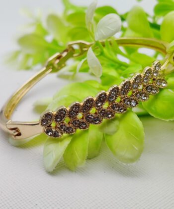 Gold-plated bracelet with a double row of crystal-paved leaf motifs.