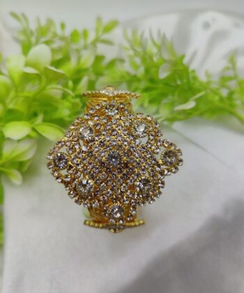 Gold plated multi-layer link bracelet displayed on a white satin cloth.