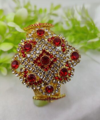 Large gold-plated floral bracelet with dense crystal embellishments.