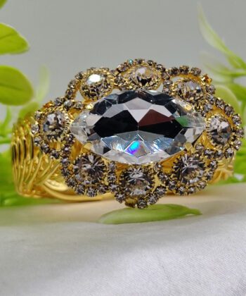 Large red oval crystal bracelet with gold-plated floral design.