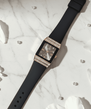 Rectangular rose gold women's watch with crystal borders and black strap.